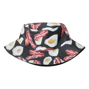 Bucket hat featuring creative fried egg and bacon food prints on a black base