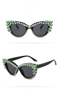 Detailed front and side views of black cat-eye sunglasses with green rhinestone accents