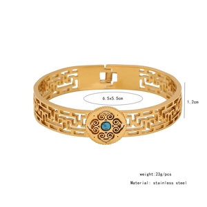 Detail view of gold stainless steel bangle with turquoise stone and dimensions 6.5x5.5cm