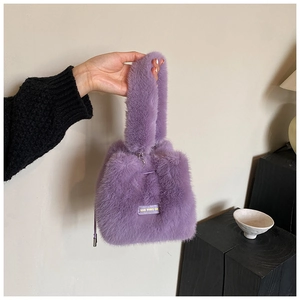Detail of purple plush faux fur bucket bag with love every day tag and drawstring closure