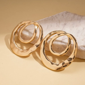 Detailed view of gold irregular double-layer hoop earrings with hammered metal texture