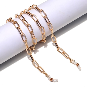 Golden minimalist metal glasses chain with flat rectangular links on a white display