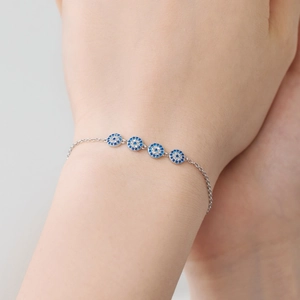 Exquisite S925 silver chain bracelet featuring four evil eye charms with blue and clear stones