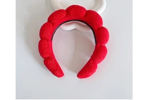 Top view of a red plush cloud headband on a white background for high volume hair styling