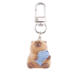 Close-up of 3D Capybara keychain holding a blue fish with a silver swivel D-ring