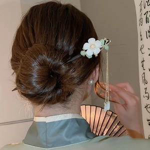 Detailed shot of white magnolia tassel hair stick styled with Hanfu and folding fan