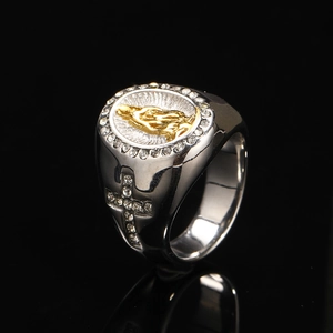 Macro detail of silver signet ring with Virgin Mary gold relief and cross crystals