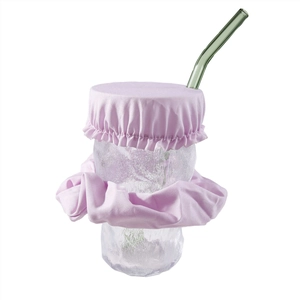 Pink fabric drink cover and matching scrunchie set shown with a glass and straw