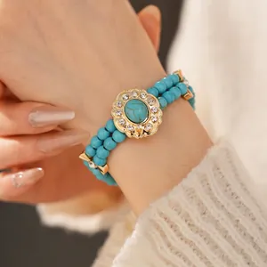 Vintage style double-row beaded bracelet with turquoise stones and floral gold pendant
