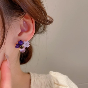 Detailed close-up of purple floral opal earrings featuring rose and flower stud design