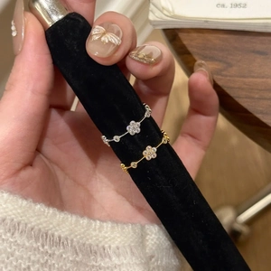 Close-up of gold and silver flower rings with sparkling rhinestones on display