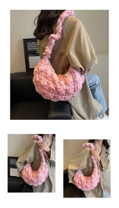 Detail of pink dumpling bag with ruched texture and matching ruffled shoulder strap