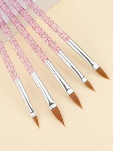 Détail de cinq pinceaux nail art avec manches à paillettes roses et pointes en fibres