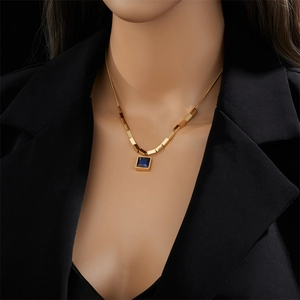 Elegant gold titanium steel necklace featuring a blue square pendant on a female model