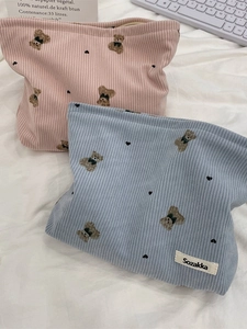 Cute bear pattern corduroy makeup bags in pink and blue colors on a soft background