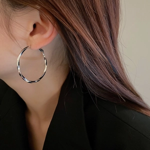Silver-plated twisted geometric hoop earrings with a minimalist sleek metallic finish
