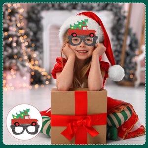Detail of Christmas glasses featuring a red truck and tree design with glitter finish