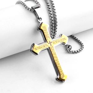 Detail shot of a double-layer silver and gold stainless steel cross pendant with Lord's Prayer