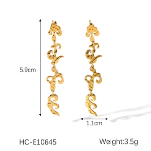Detailed view of abstract gold thread relief earrings with exact dimensions 5.9cm x 1.1cm