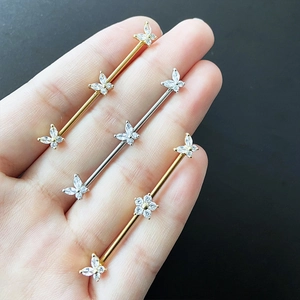 Set of stainless steel industrial barbell earrings with butterfly and flower crystal motifs