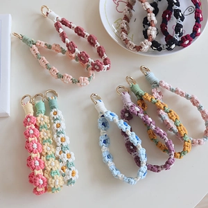 Handmade woven floral wristlets with golden rings in various pastel color options