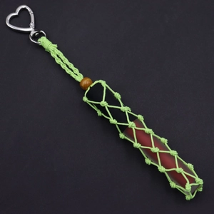 Macro detail of hand-woven fluorescent green lipstick holder with silver heart clip