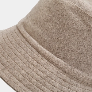 Close-up of the fine stitching and soft terry cloth texture on a beige bucket hat