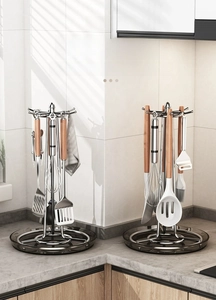 Rotating kitchen utensil rack with stainless steel tools and wooden handles on countertop