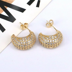 Elegant gold crescent stud earrings with white cubic zirconia in a 45-degree top view
