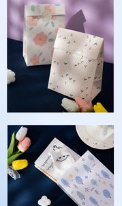 Detailed view of floral gift bags and matching seals in a cozy, aesthetic setting