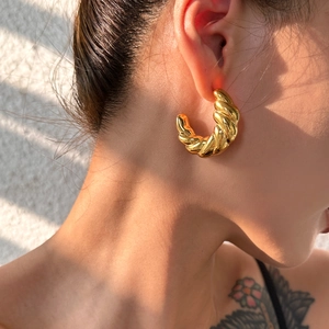 Chic 18k gold plated stainless steel twisted hoop earrings shown on a model