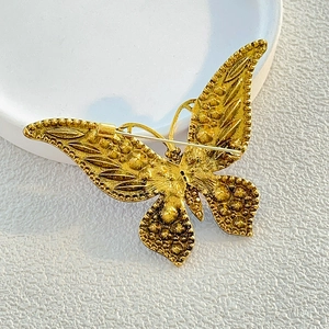 Elegant gold butterfly brooch with vintage textured metal and secure pin closure