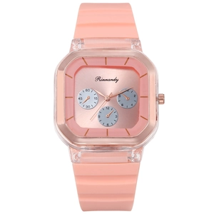Detailed view of square rose gold watch face with orange silicone strap and transparent case