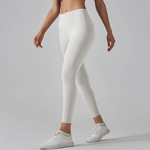 Detail view of high-waisted white yoga leggings featuring functional side pockets and matte fabric
