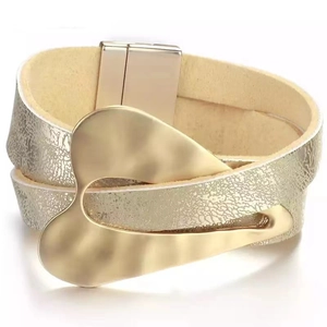 Detailed view of beige faux leather wrap bracelet with golden irregular metal magnetic clasp