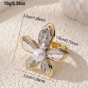 Detail showing weight and size of vintage petal ring with silver hammer texture and pearl