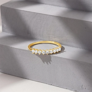 Detailed macro view of S925 sterling silver stamp and nine round diamonds on gold ring band