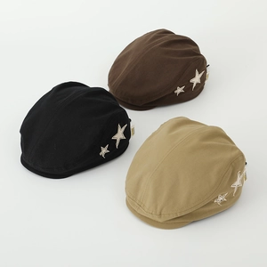 Detail view of cotton flat caps in three colors featuring star patches and side labels