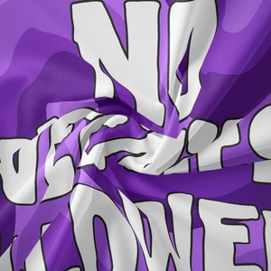 Close-up of purple bohemian tapestry fabric with bold white lettering and twill texture
