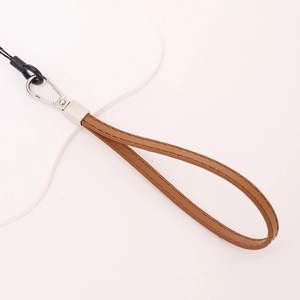 Detail of brown PU leather wrist strap with silver metal clasp and fine stitching