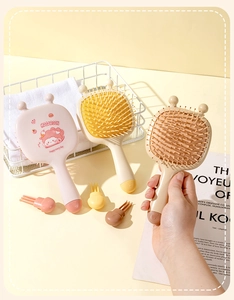 Detailed view of colorful cartoon hair brushes with soft massage air cushions and handles