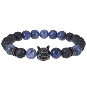 Macro detail of 8mm blue tiger eye beads and black wolf head charm with green eyes
