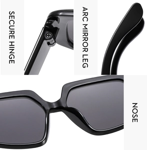 Detail view of secure metal hinges and ergonomic arc temples on black oversized sunglasses
