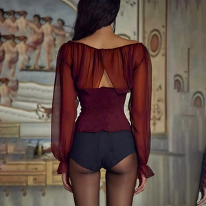 Detail view of the back of a deep red sheer chiffon top with tie-up cutout and ruched fabric