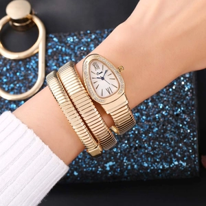 Detailed close-up of a gold snake-shaped wrap watch with a crystal teardrop dial