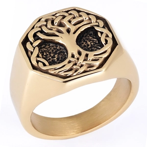Macro detail of golden tree of life relief on a hexagonal vintage stainless steel ring