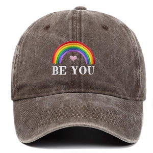 Detailed view of rainbow and BE YOU embroidery on a vintage washed cotton baseball cap