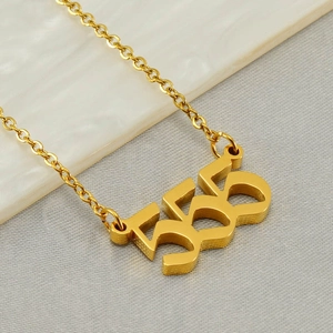 Macro shot of polished gold-finished stainless steel 555 angel number pendant necklace
