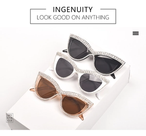 Detail of cat eye sunglasses with rhinestones in black, white and brown colors