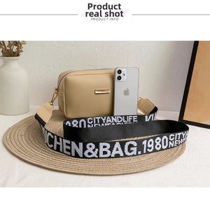 Compact beige lychee textured crossbody bag shown with smartphone for size comparison
